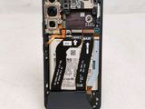 the back of a cell phone with a broken battery attached to it