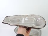 a person holding a plate in their hand on a white background