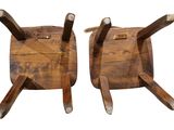 pair of wooden chairs with metal legs on a white background