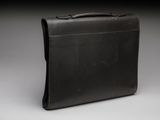 leather briefcase on grey background with copy space for text