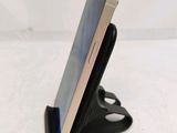 a cell phone that is sitting on top of a stand