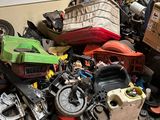a pile of assorted motor parts in a garage