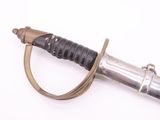 a silver and black sword on a white surface