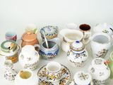 many different types of teapots and saucers on the table