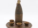 a picture of a bottle and cups on a tray