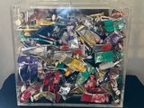 a clear box filled with assorted candy on a table