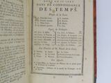 a book open on a white table with a black and white title