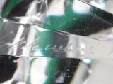 a close up of a glass object on a white surface