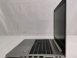 a laptop that is sitting on a white surface