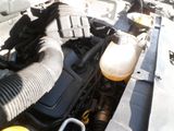 a close up of a car ' s engine with the hood open