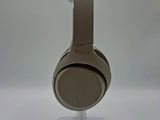 the headphones are sitting on a stand on a white surface