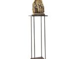 a statue of a group of people standing on top of a metal stand