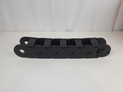 a close up of a black plastic chain on a white surface