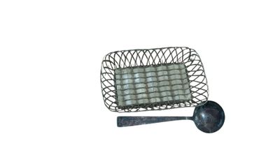 a small metal basket with a spoon and spoon rest on it