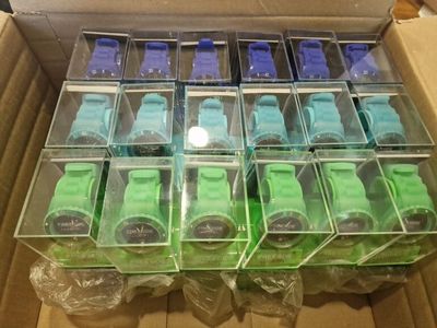a lot of green and blue toy cars in a box