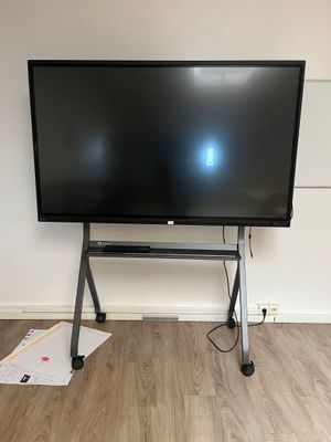a flat screen tv sitting on a stand in a room