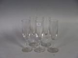 four empty wine glasses sitting on a table with a number on them