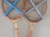 deux raquettes de tennis posées par terre l'une à côté de l'autre