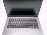 an open laptop computer sitting on top of a white table