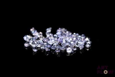some very pretty purple diamonds on a black surface