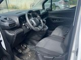 the interior of a car with the door open and the driver ' s seat down