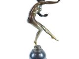 bronze statue of a woman holding a tennis racquet on a marble base