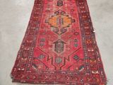 rug on the floor in a room with a chair in the background