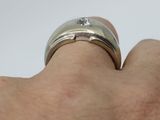 a close up of a person ' s hand with a ring on it