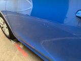 a blue car that is parked on the side of the street