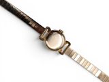 an image of a close up of a wrist watch on a white surface