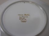 a white plate with gold writing on it on a table