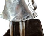a statue of a woman with a purse on a table