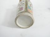 a white vase with a floral design on it on a table