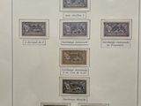 an old picture of a collection of stamps on display in a glass case