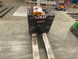 a fork lifter that is sitting in the middle of a warehouse