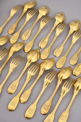 a lot of forks and spoons that are on the table