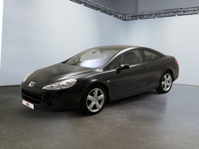 une photo d'une voiture noire dans une pièce blanche