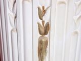 a close up of a white vase with a bird on it