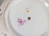 a white plate with a pink and yellow design on it