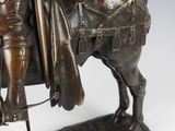 bronze statue of a man on a horse with a sword