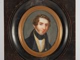 portrait of a young man in a black coat and white shirt