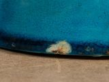 a close up of a blue bowl on a table