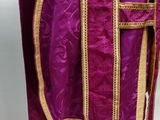 a close up of a purple robe with gold trim