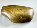 a rock that has writing on it on a white surface