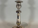 a silver candle holder on a table with a white background