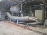 a large metal pipe in the middle of a building