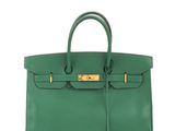 a green leather handbag on a white background