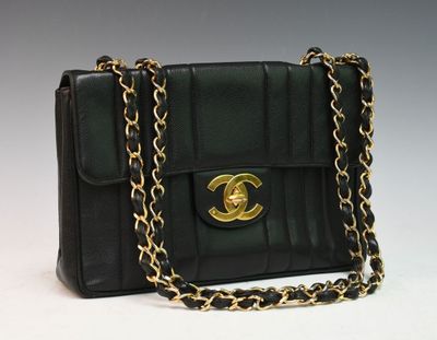 a close up of a black purse with a chain around it