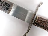 a knife that is on top of a piece of wood