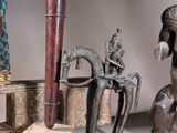 many different types of african figurines displayed on a table